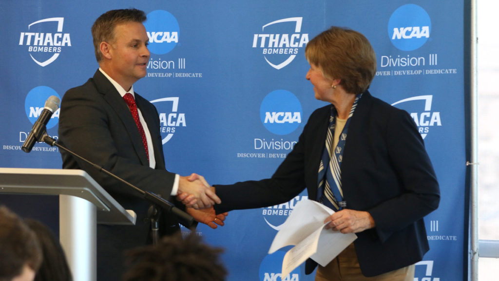From left, Mike Urtz, Director of Athletics at SUNY Cortland and Susan Bassett, Associate Vice President and Director of Intercollegiate Athletics and Recreational Sports, shake hands after the announcement of the 61st annual Cortaca Jug being played at MetLife Stadium in East Rutherford, New Jersey.