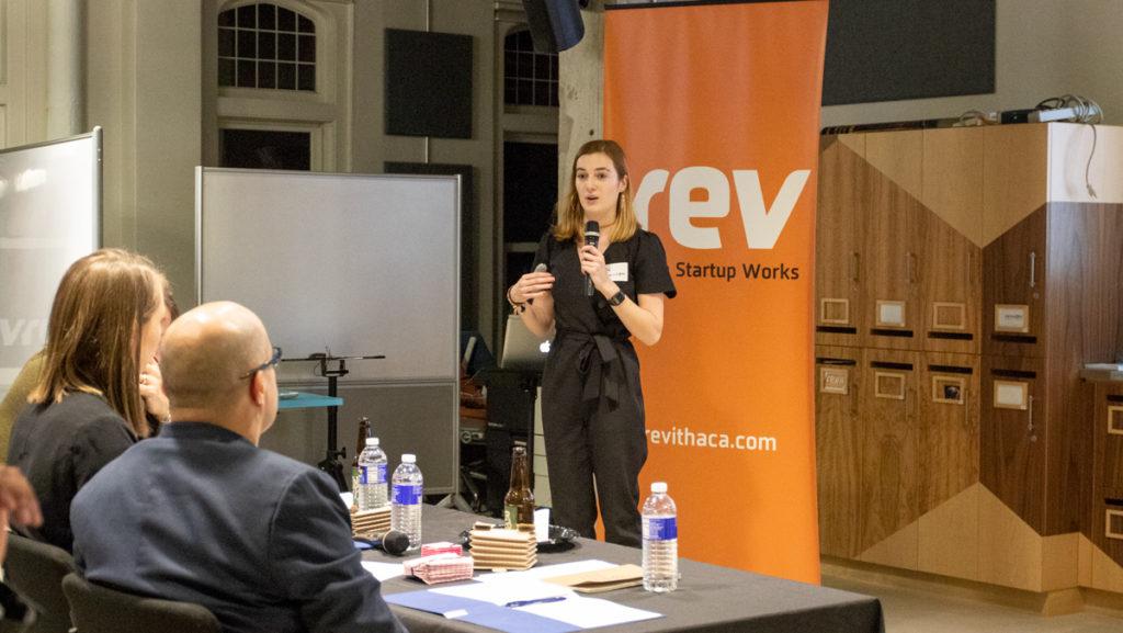 Junior Lily Dickinson presents her product Flatbox, a collapsible container for clean and dirty pocket tissues, to the judges. Her product was one of seven pitched at the third annual Demo Day held at Rev: Ithaca Startup Works on Nov. 13.