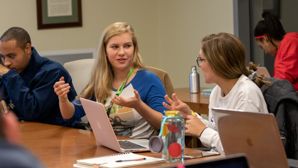 From left, senior Seondre Carolina, SGC vice president of business and finance; freshman Abigail Murtha, senator for the School of Health Sciences and Human Performance; and sophomore Allison Kelley, senator for the business school at the Nov. 7 SGC meeting. 