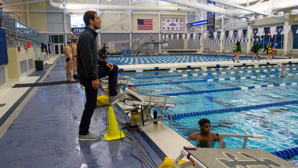 Andrew Marsh, graduate student assistant coach, helps run the men’s swimming team practice. Marsh was a Big 12 champion at West Virginia University during his senior year.