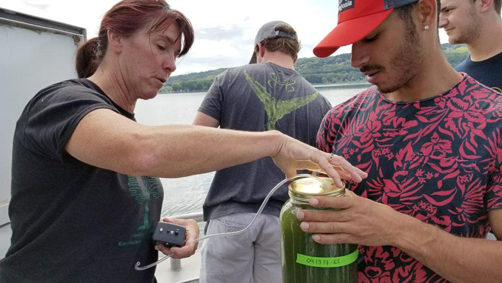 From left, Susan Allen-Gil, professor in the Department of Environmental Studies and Sciences, and Trevor Strother ’18 conduct research on microplastics in Cayuga Lake. The research will be used in a plastic bag ban proposal for Tompkins County. 