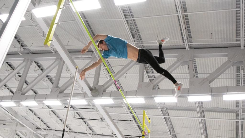 Freshman pole vaulter Dominic Mikula clears the bar during practice in Glazer Arena. Mikula broke his own pole vault record with a height of 4.80 meters Jan. 26.