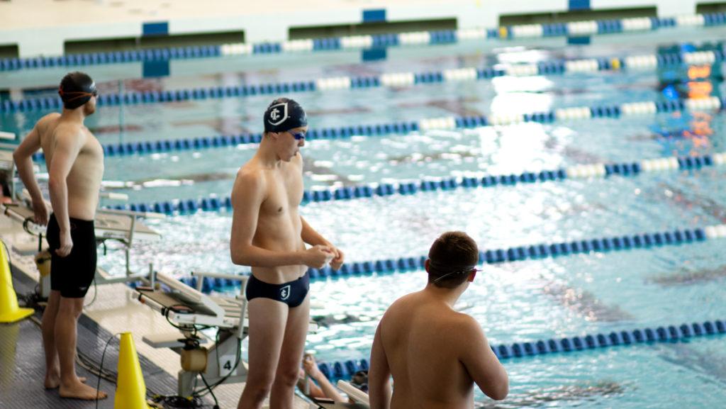 Three swimmers look toward the pool before their race at the Senior Day meet against Alfred University on Jan. 26. The Bombers added 12 freshman to their roster this season. 