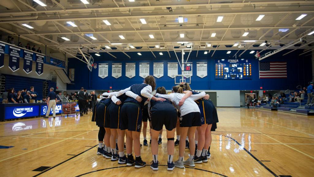 Members of the Ithaca College womens basketball team huddle up during their pre-game warmups