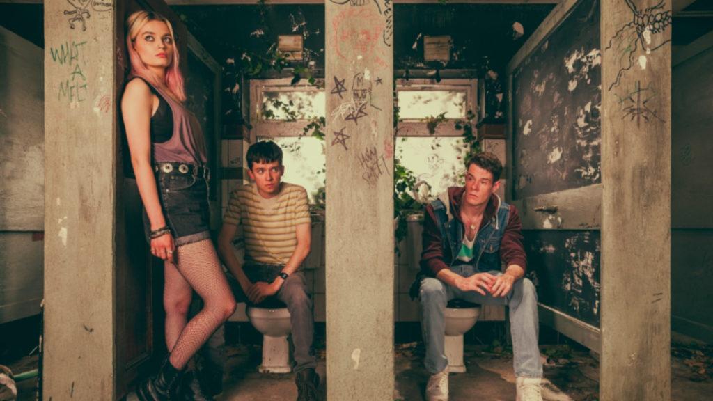 From left, Maeve (Emma Mackey), Otis (Asa Butterfield) and Adam (Connor Swindells) secretly discuss Adam's insecurities in an abandoned wing of their secondary school. 