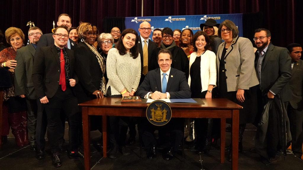 Luca Maurer, director of the Center for LGBT Education, Outreach and Services, far right, attends Gov. Andrew Cuomo’s signing of the Gender Non-Discrimination Act on Jan. 25, which bans gender identity discrimination in the state.
