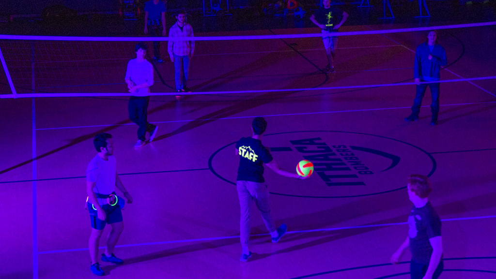 Students play glow-in-the-dark volleyball as part of the Neon Climb event Feb. 8 in the Fitness Center. The event included esports, glow-in-the-dark basketball, glow-in-the-dark rock climbing and more. It also included food and music to entertain students. 