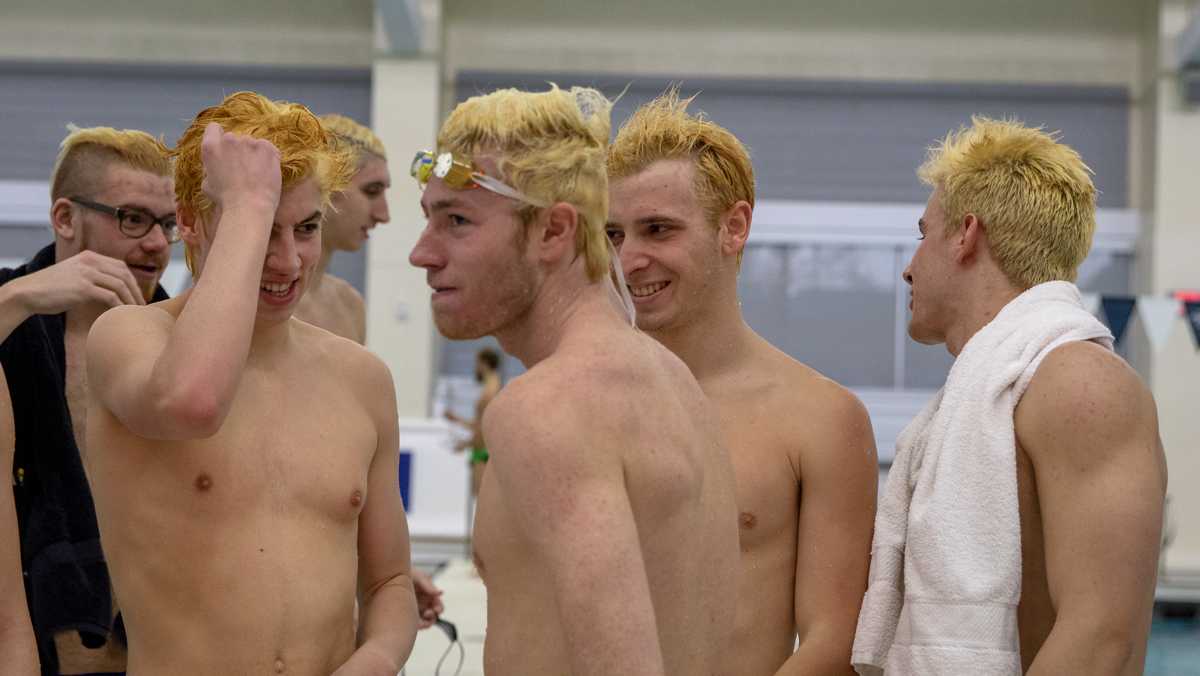 Men’s swimming team goes for gold with bleached hair
