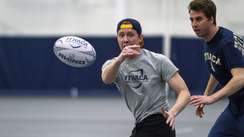 Freshman Thomas Frevele makes a pass while pursued by junior Brendan OGrady during the rugby teams practice in Glazer Arena on Feb. 27.