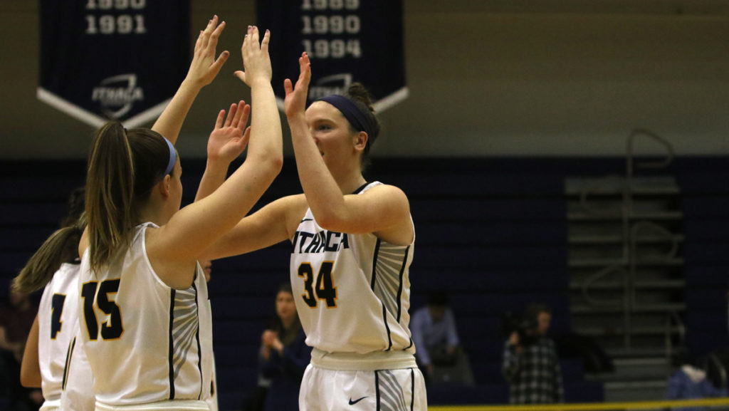 Junior forward Cassidy OMalley and senior Meghan Pickell high five during the Bombers game against the Rochester Institute of Technology. The Bombers fell to the Engineers 64–52