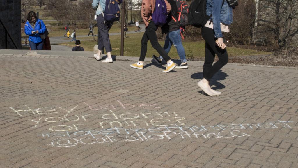 Examples of catcalls are written in chalk near the Ithaca College Library. They are a part of the Catcalls of Ithaca Instagram campaign, which seeks to raise awareness about forms of sexual harassment that occur on campus.