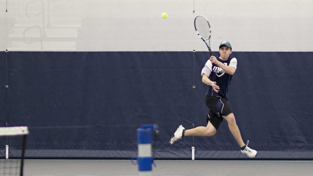 Junior Ryan Buchanan returns a volley during the club tennis teams practice March 31 in Glazer Arena. The team has more than twice as many freshmen as the varsity squads.