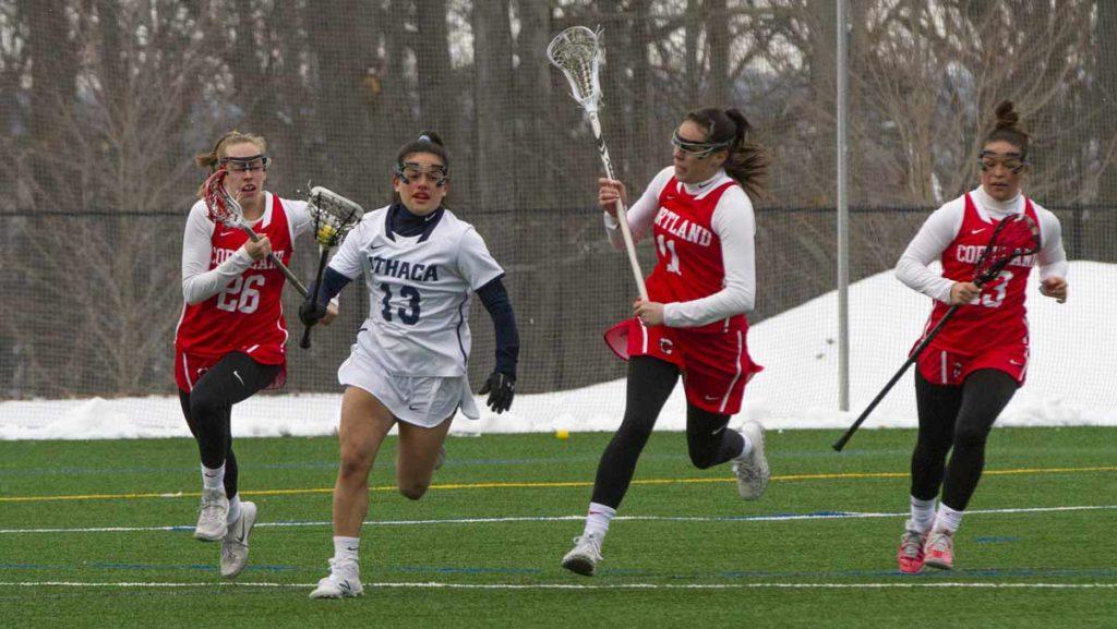 Sophomore defender Molly Nodiff breaks away from a group of Cortland attackers during the Bombers home opener against Cortland on March 2. The Bombers ultimately lost the contest 11–8.