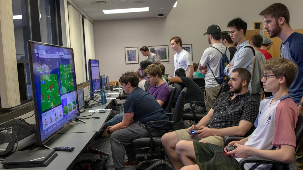 Members of the Ithaca College Esports Club gather to watch and compete in Friends Hall in April 2019.