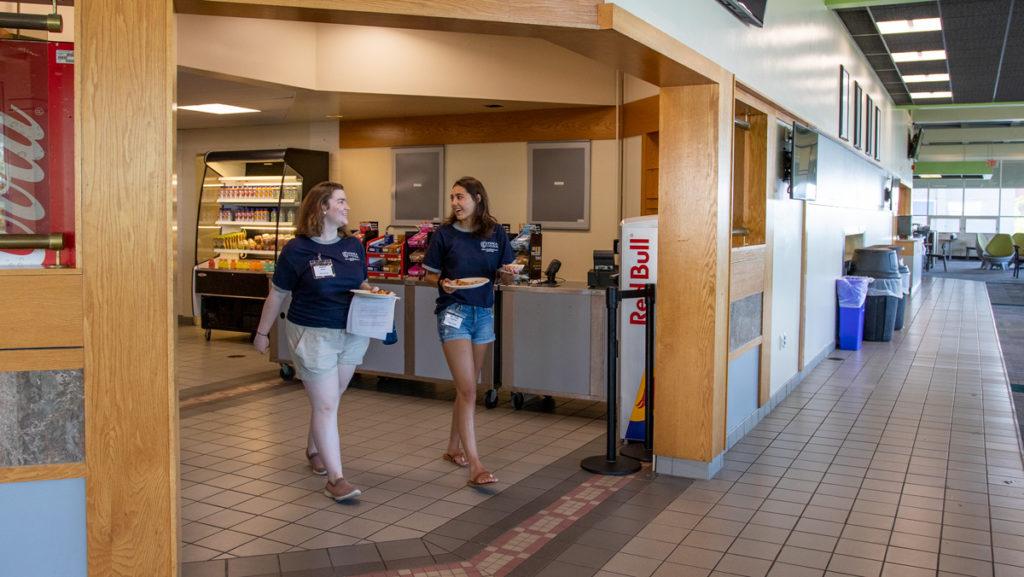 From left, junior Maria White and sophomore Peyton Fleming eat in Towers Marketplace, formerly Towers Dining Hall. Ithaca College has brought in more retail dining locations as part of its new self-operated dining program.