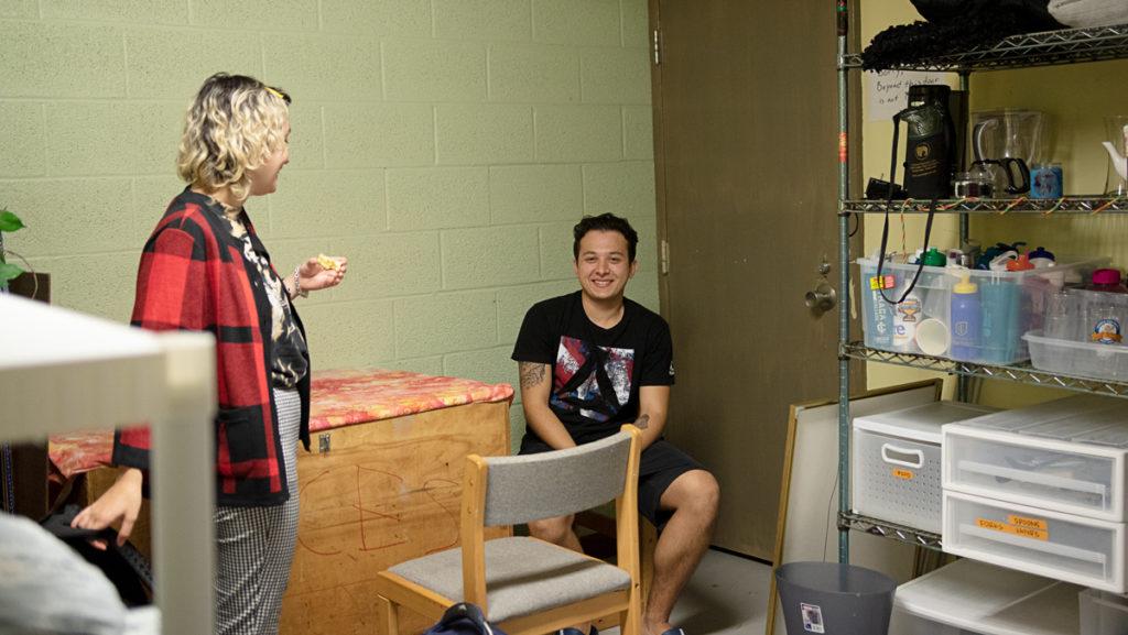 From left, juniors Gemma Gallucci and Bryan Robles sit in the Take It Or Leave It (TIOLI) room in the basement of Clarke Hall. TIOLI is a way for students to reuse old items instead of buying new ones and wasting resources.