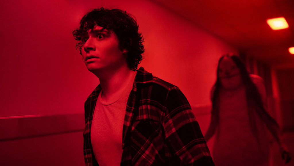 The Pale Lady ominously stalks a teenager through a red-lit hallway in André Øvredal’s PG-13 adaptation of the children’s book series “Scary Stories to Tell In the Dark.” The film, despite being rated for younger audiences, incites fear.