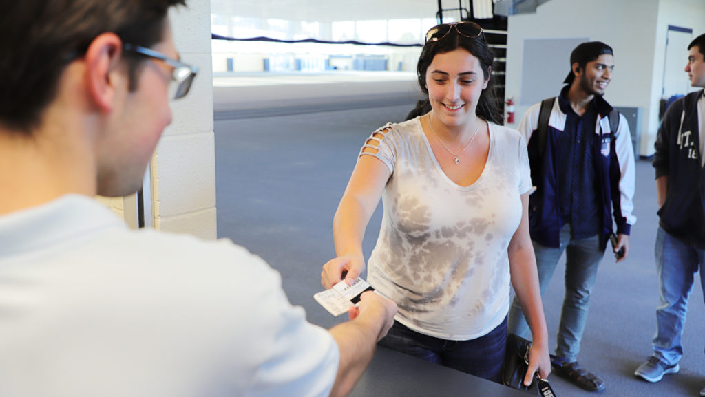 Junior Alyssa Haber receives her ticket for Cortaca 2019 at the Ithaca College on-campus ticket sales on Sept. 20. The 2019 competition will be played off-site at MetLife Stadium in East Rutherford, New Jersey.