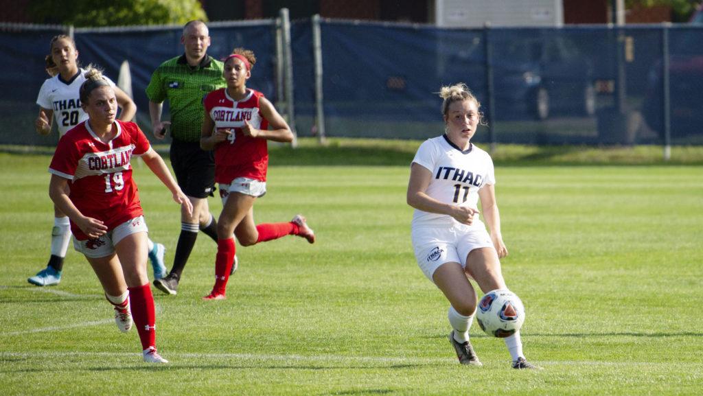 Freshman+forward+Delaney+Rutan+plays+the+ball+away+from+defenders+during+the+Bombers+game+against+SUNY+Cortland+on+Sept.+11.+