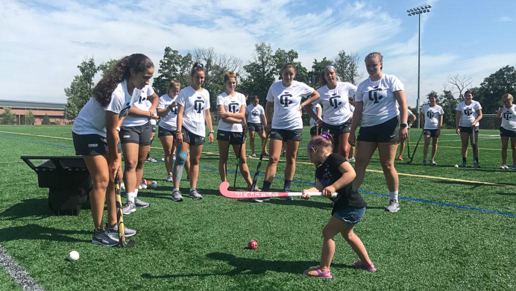 Nora Zelko, a 3-year-old with neuroblastoma, practices with her new teammates on the Ithaca College womens field hockey team Aug. 17 after they officially adopted her through the Friends of Jaclyn Foundation.