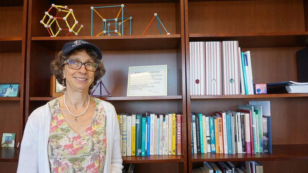 Melanie Stein, the new dean of the Ithaca College School of Humanities and Sciences, dons her H&S hat. Stein said she wants students and faculty in the school to have a stronger identity.