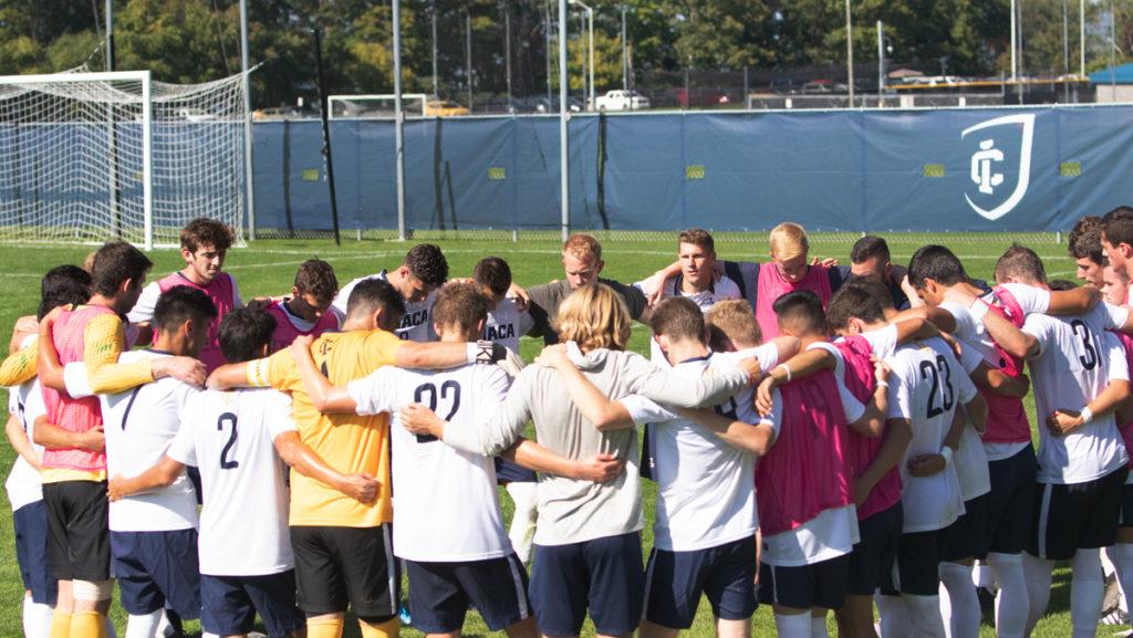 The Ithaca College mens soccer team shares a motivational moment in a huddle before their game on Sept. 24, the Bombers currently hold a record of 6-1-1. 