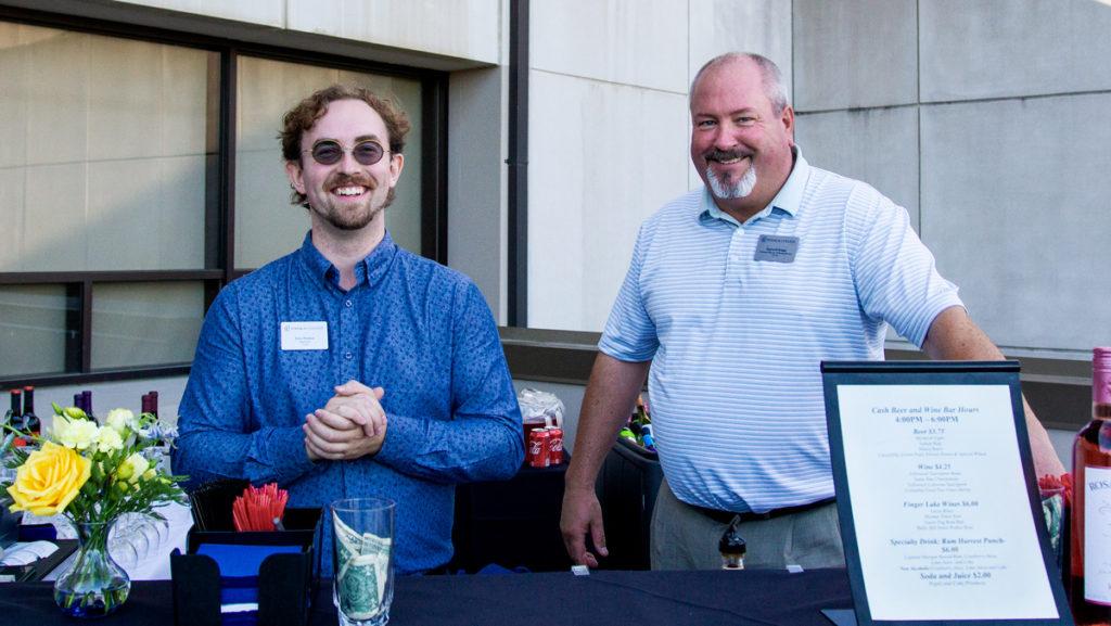 From left, Ithaca College Dining employees Ezra Thomas and Reginald Briggs bartend the first Pop-Up Pub of the fall semester Friday, Sept. 20 at the Campus Center East Terrace. 