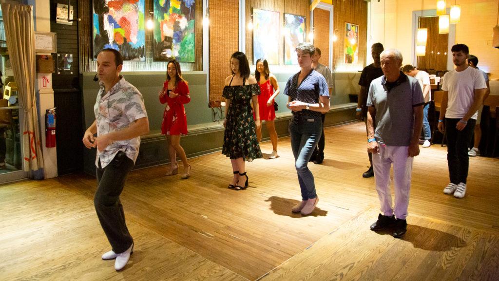 Michael Luis Ristorucci teaches Latin dance to a group of Salsa Night attendees. Salsa Night offers lessons for new dancers from 10 to 10:30 p.m. before the event opens to the general public. 