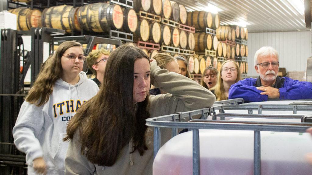 Freshman Kelly Sgombick and the rest of the Farm to Table: Conscious Cuisine for the 21st Century Seminar visit the store room of Finger Lakes Distilling to learn how farm fresh food and drink products are made.