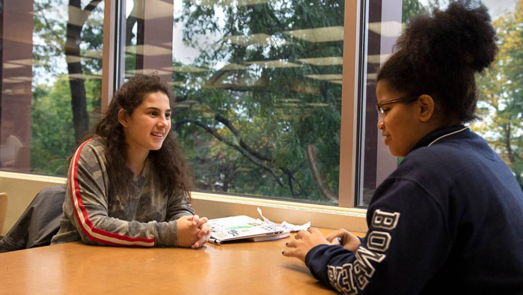 From left, sophomore Ithaca Ambassador Kaitlyn Katz works with freshman Sherleen Vargas to help reduce her nervousness about an upcoming dance performance.