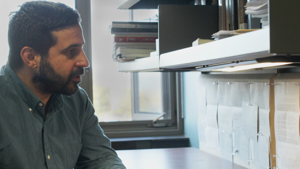 Raul Palma, assistant professor in the Department of Writing, examines letters of advice written by Cuban writers that he received prior to his trip. 