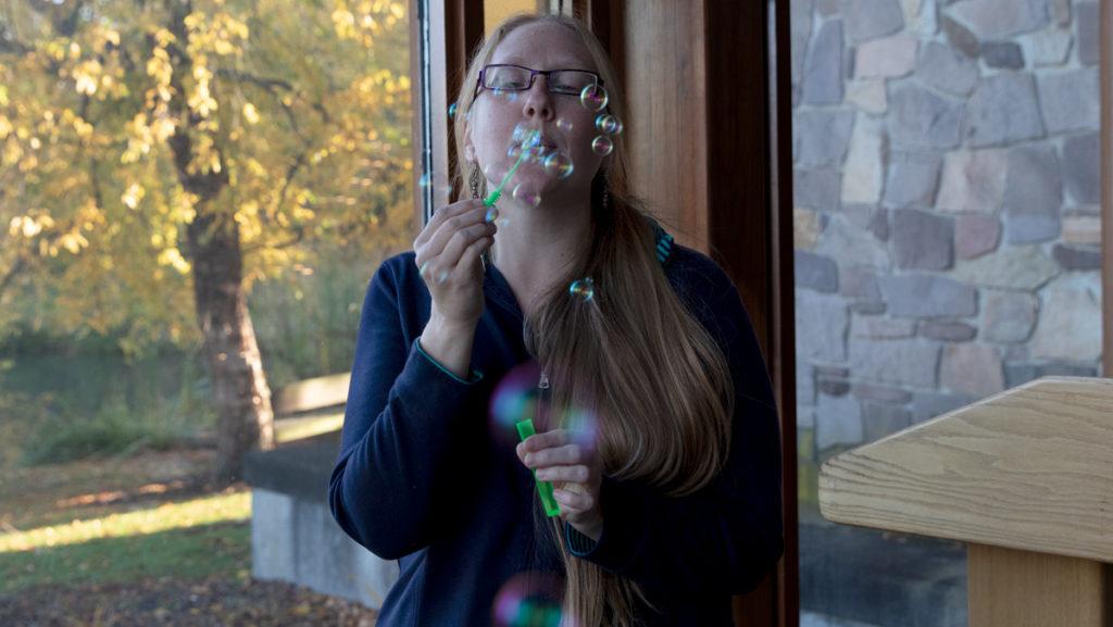 Kristen Lind, health promotion specialist in the Office of Counseling and Wellness ,blows bubbles to illustrate some of the breathing techniques used through THRIVE@IC.