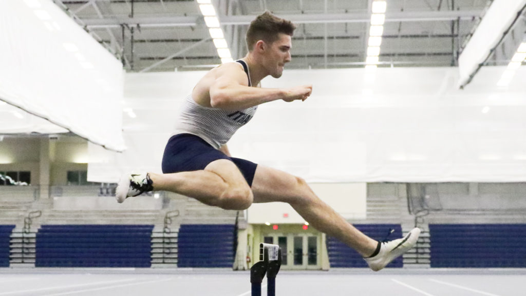 Senior Rob Greenwald hurdles during a practice in Glazer Arena. Greenwald competes in the heptathlon during the indoor track season.