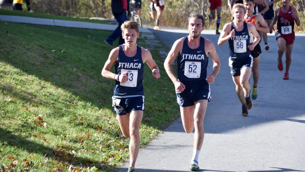 Senior runners John Blake and Patrick Robertson lead a pack of runners during a cross-country race. 