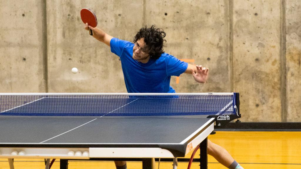 Junior Ioan Dascalu prepares to return the ping pong ball during a club practice Nov. 20. in the Fitness Center.
