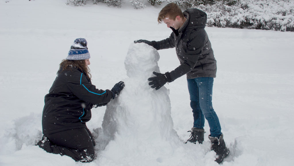 Freshmen Nathan Guay and Allison Hillebrandt work together to build a snowman on the Dec. 2 snow day. Approximately 6–12 inches of snow were expected in Ithaca during this time as the storm blew through the area.