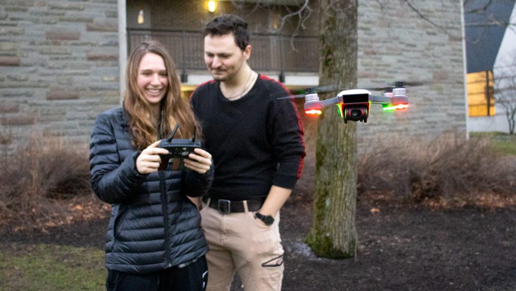 From left, freshman Ani McMannon and Nick Matacchieri fly a DJI Spark drone outside of Eastman Hall on Jan. 28.