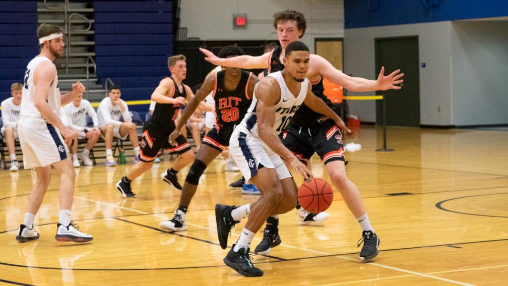 Senior guard Sebastian Alderete protects the ball from a RIT defender in a Liberty League match up Jan. 14