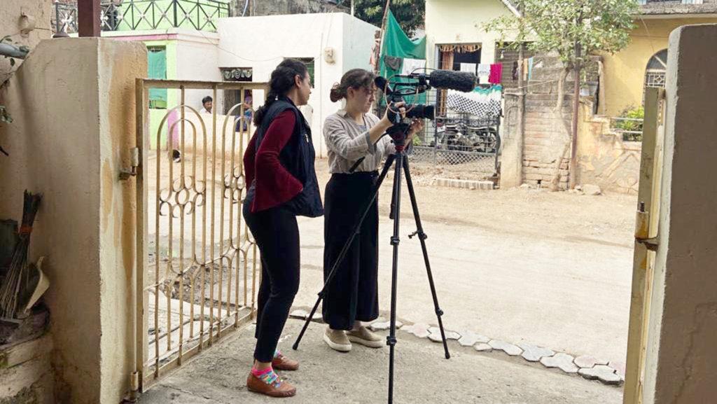 From left, Shraddha Potdar and Ithaca College senior Alisha Tamarchenko work in tandem to create a documentary in Amravati, India. 