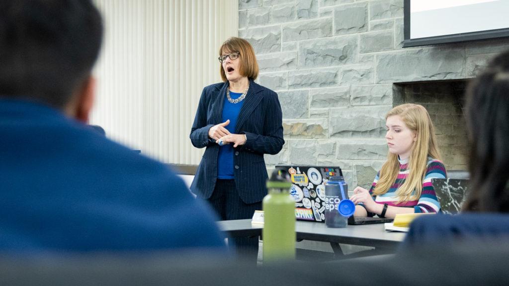  From left, Dean of Students, Bonnie Prunty speaks to junior Abigail Murtha Student Governance Council (SGC) senate chair and the SGC about housing process issues and fall orientation Jan. 27.