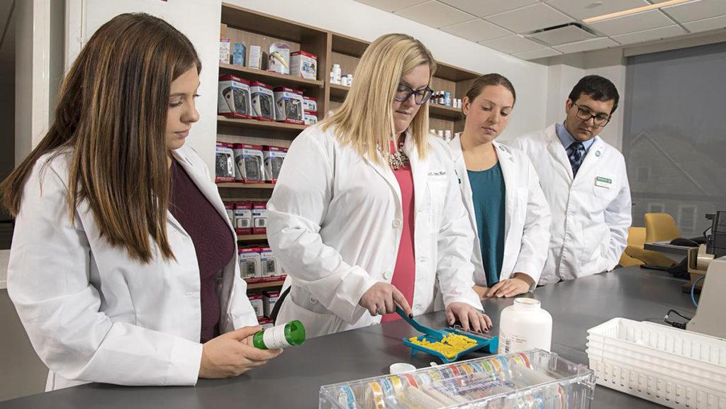 Students work with Clinical Assistant Professor Emily Leppien in the community pharmacy at the School of Pharmacy and Pharmaceutical Sciences at Binghamton University in Binghamton, New York. 