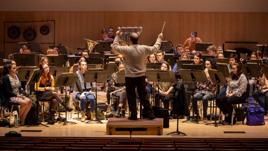 Chris Hughes, associate professor in the Department of Performance Studies, conducts the wind ensemble as it rehearses on the first day of classes of Spring 2020 on Jan. 21 in Ford Hall in the James J. Whalen Center for Music.