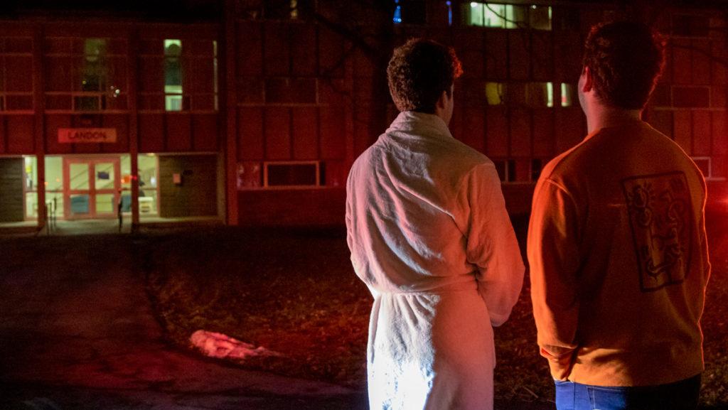 From left, freshmen Jake Maskell and Sam Zucker wait to hear if they can re-enter Landon Residence Hall after a fire extinguisher was set off, forcing residents to evacuate.