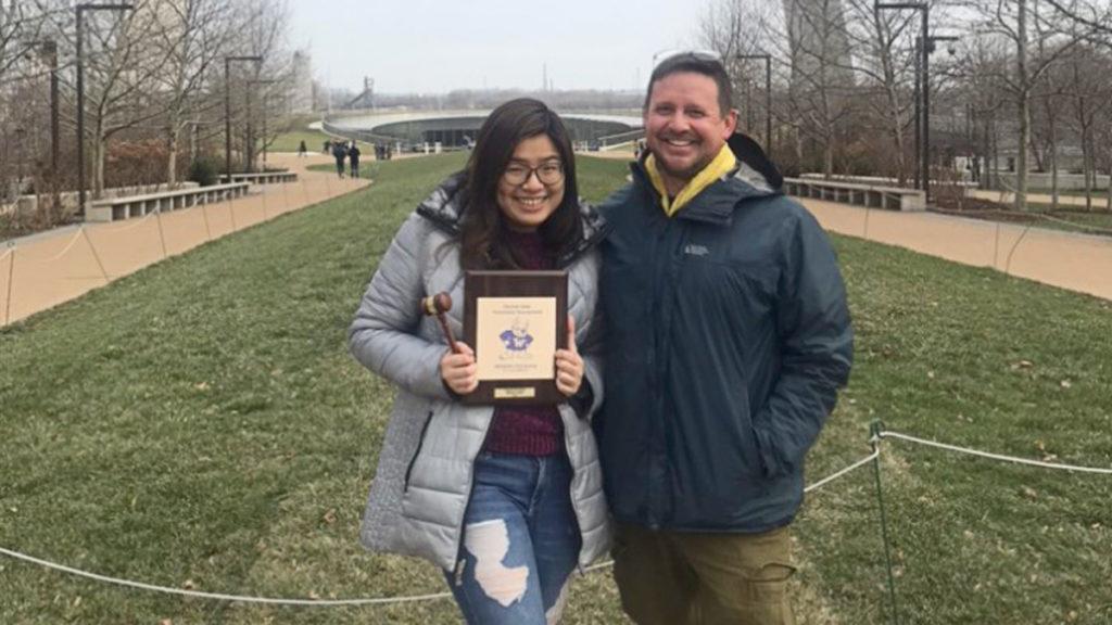 Junior Callie Nguyen poses with Scott Thomson, assistant professor in the Department of Communications Studies and coach and adviser of the speech and debate team, after winning the championship title.