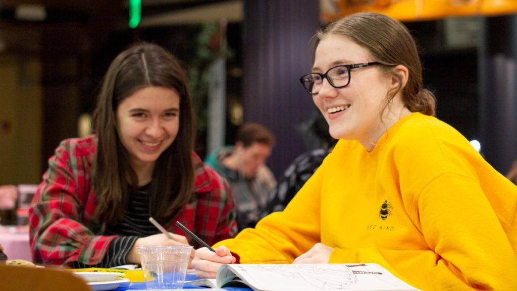 From left, freshmen Lila Weiser and Tori Postler color in Frozen-themed coloring books at the Palentine's Day celebration Feb. 15 in Campus Center. The Student Activities Board hosted the event, which featured food, crafts and a showing of Frozen 2.