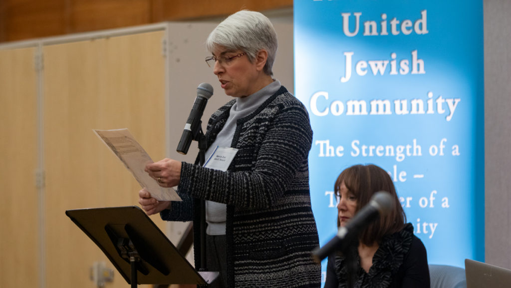 Marica Zax, chair of Ithaca Area United Jewish Community, introduces the panel which consisted of three guest speakers to share their first and second hand experiences from the Holocaust on Feb. 2. 