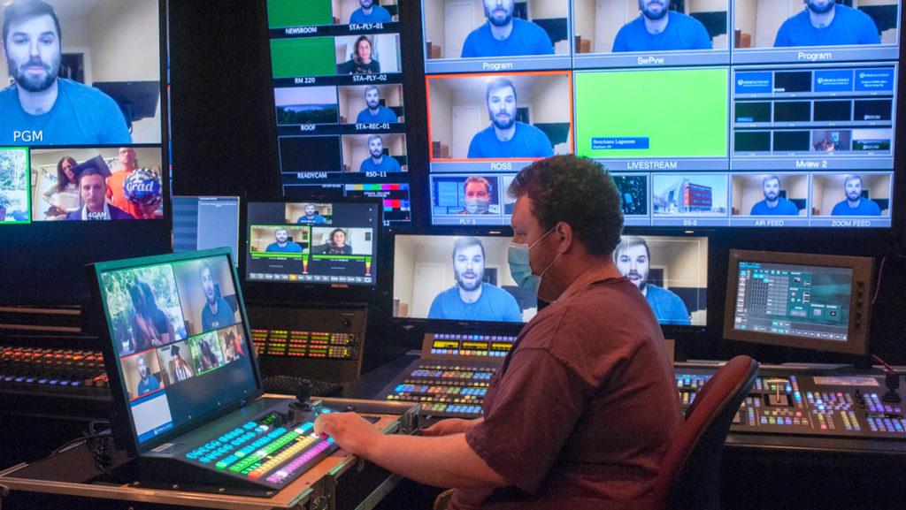 Griffin Schultz 17, technical director and graphics producer, operates the video switcher in Control Room A during one of five virtual graduations for the 2020 graduates.
