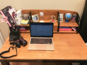 Above view of desk with laptop and camera