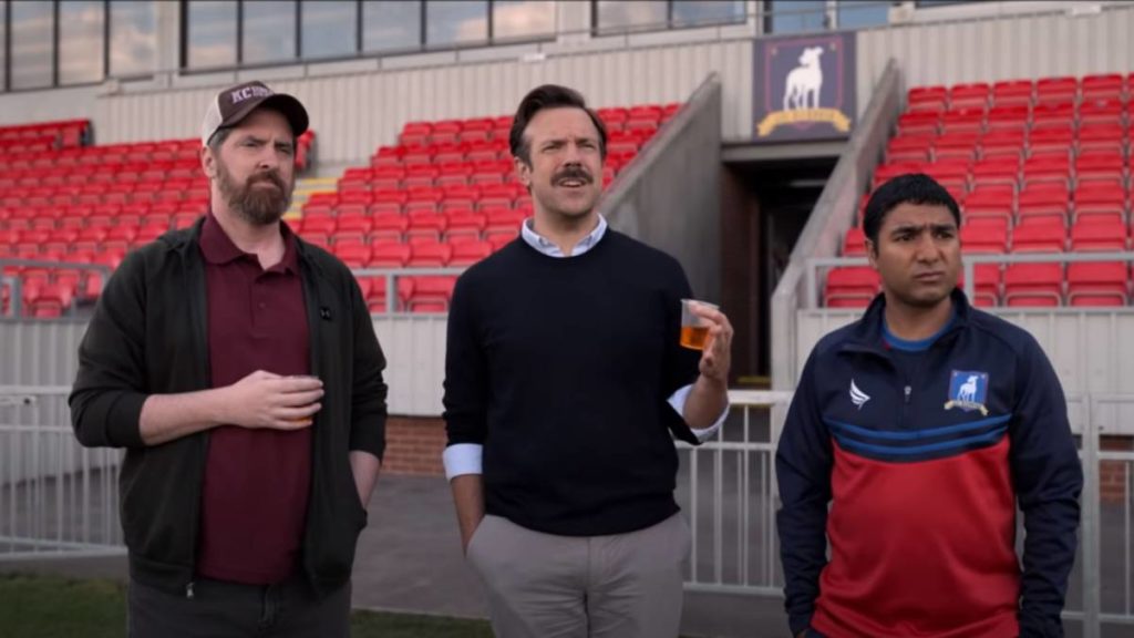  “Ted Lasso” is a delightful series following the titular American football coach as he makes the transition to coaching soccer in the English Premier League. The character Ted Lasso originally appeared in advertisements for the English Premier League.