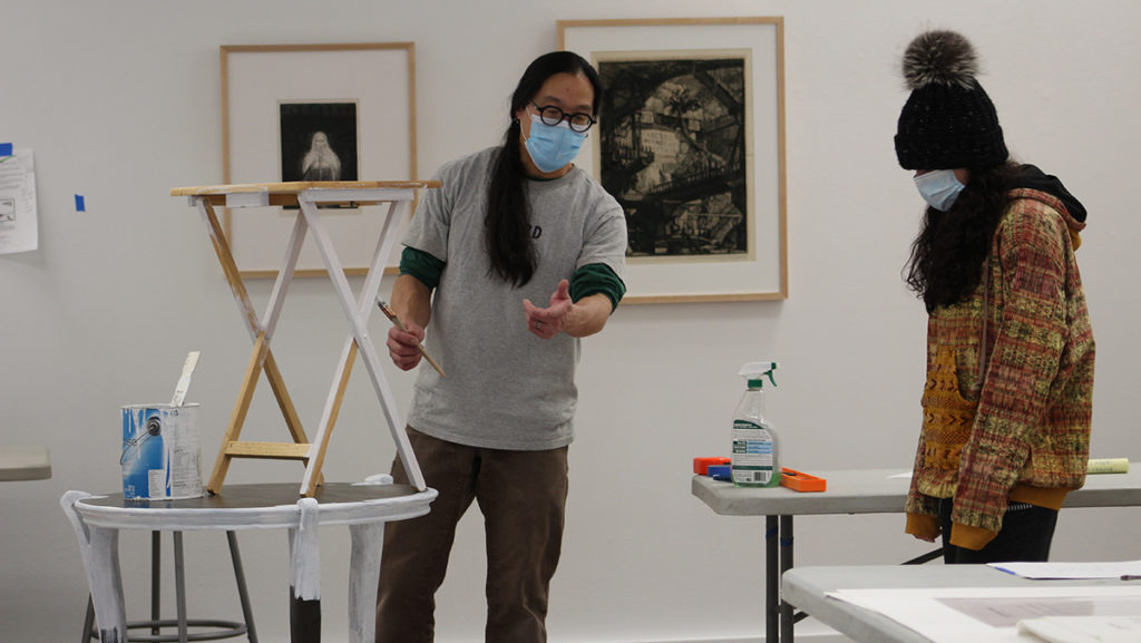 Art Preparator Brian Quan and senior Annie Shaw are working hard to prepare the Handwerker Gallery for its opening Feb. 24.